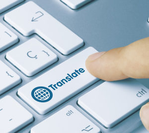 Photo of a person's finger clicking on a keyboard key that says Translation